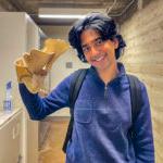 tommy shenoi holds up a mushroom