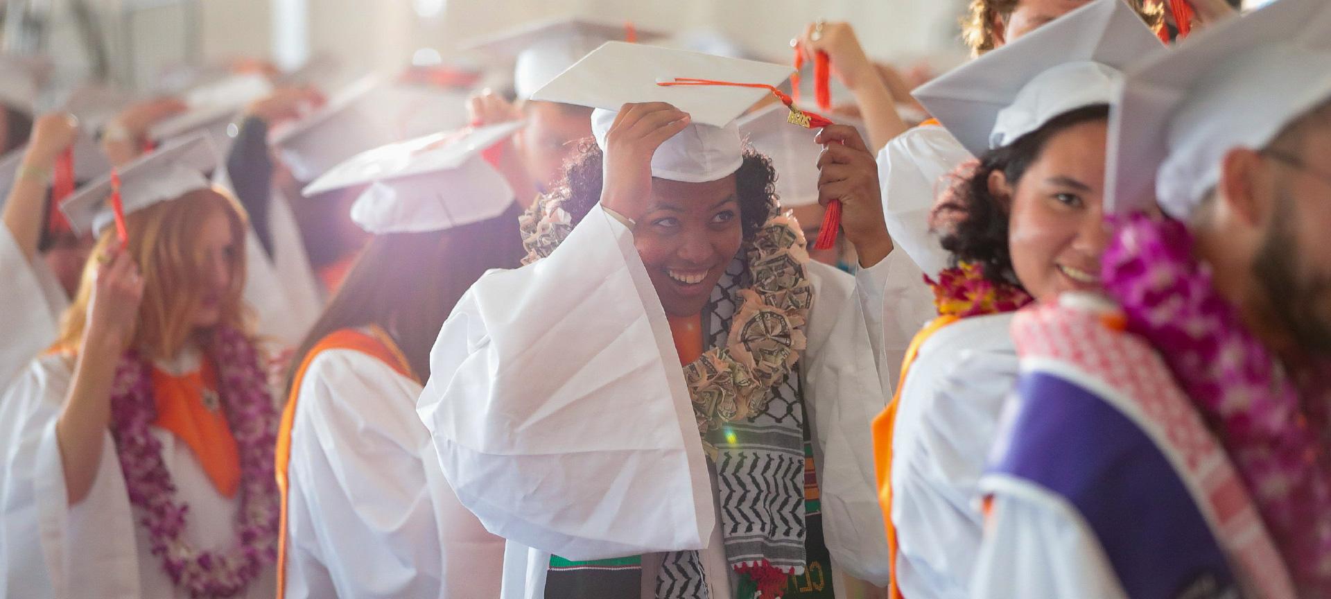 a crowd of graduates wait in line